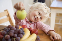 Blonder Junge mit Obst